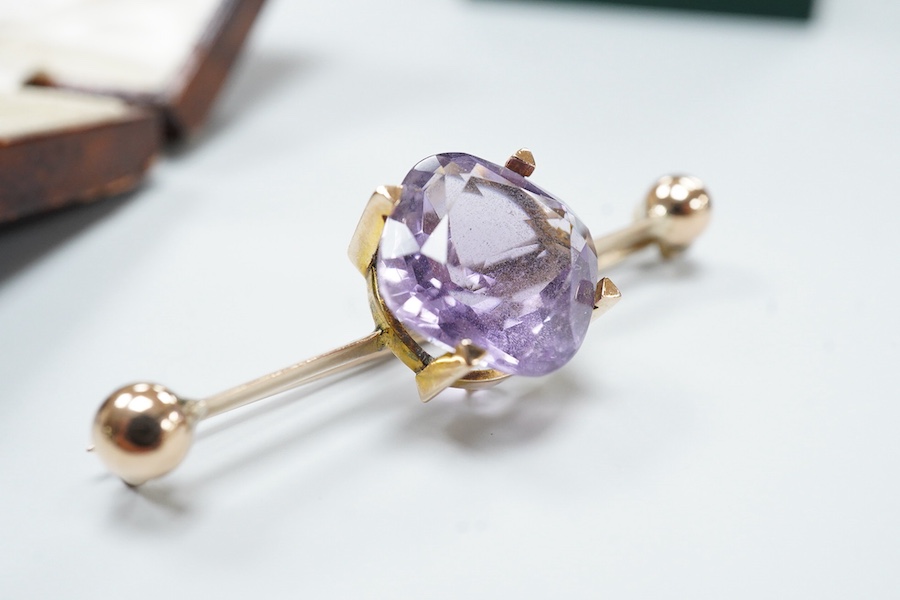 A cased late Victorian 9ct and single stone amethyst set bar brooch, 45mm, a cased yellow metal and single stone white opal set stick pin and a modern 18ct white gold, ruby and diamond cluster ring, size L/M.